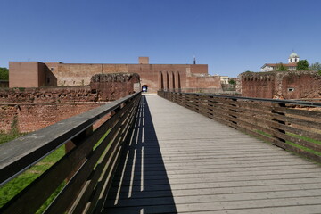 Novara Castle. Wooden bridge and brick castle walls. Novara Castle renovated with new walls and...