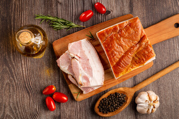 Sliced ​​raw bacon on the table.
