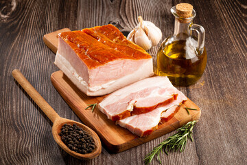 Sliced ​​raw bacon on the table.