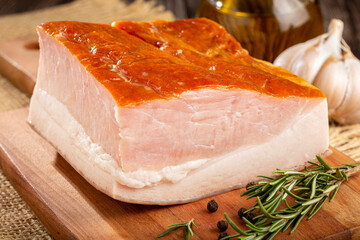 Sliced ​​raw bacon on the table.
