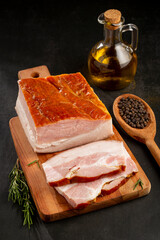 Sliced ​​raw bacon on the table.