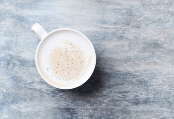 Coffee with milk on wooden background. Top view. Close up. Copy space.