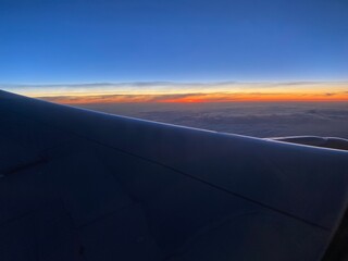 Fototapeta na wymiar view from airplane on the red sunrise.