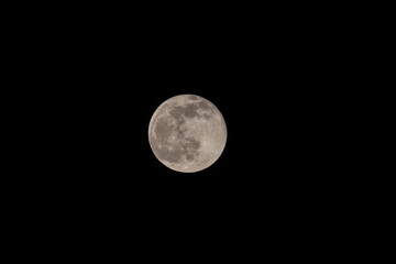 Super full moon with dark black background for placement in video, banner, shot in march 2022, Antwerp, Belgium. High quality photo