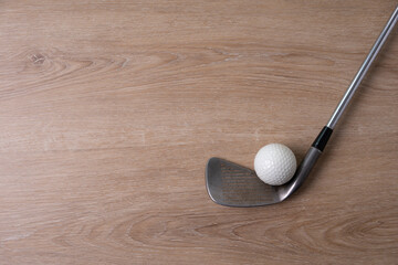 golf ball and golf club on wooden table background, sport concept