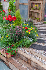 Fototapeta na wymiar Colorful flower and path in backyard garden