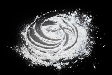 Pastry or recipe on a dark background sprinkled with wheat flour. Preparing for baking, top view on a black background or table. Preparation of dough or dough.
