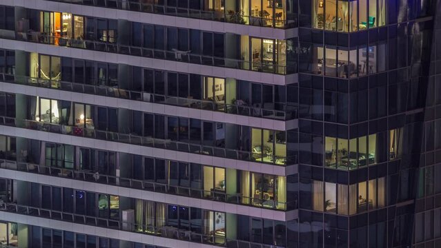 Windows lights in modern office and residential buildings timelapse at night