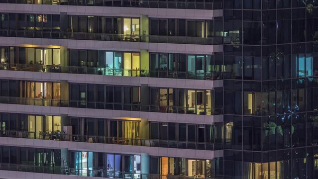 Windows lights in modern residential buildings timelapse at night