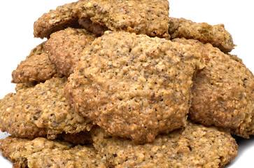 Homemade oatmeal cookies in a pile isolated against white
