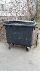 plastic trash can on the street on a sunny morning