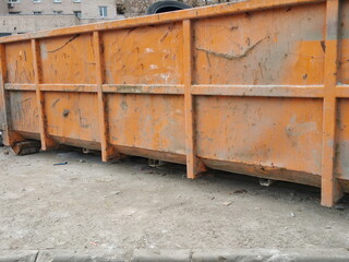 Metal trash can on the street on a sunny morning