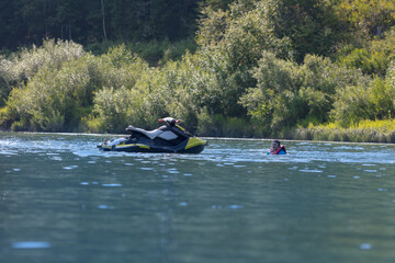 the rider fell from a jet ski and drowns in a mountain lake far from his transport. Summer tourism and recreation on the water. To advertise life jackets on reservoirs