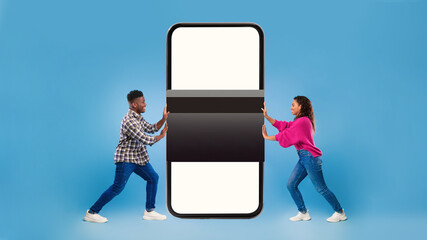 African Couple Holding Credit Card Near Smartphone Screen, Blue Background