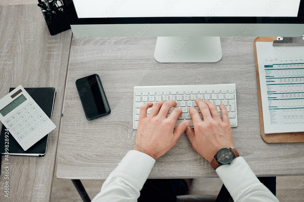 Aufkleber Working towards success. High angle shot of an unrecognisable businessman sitting alone in his office and using his keyboard.