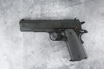 Black semi-automatic pistol on concrete