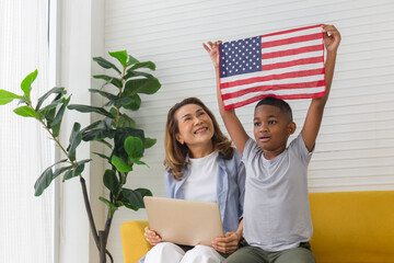 Little boy holding USA flag in living room, Child spending happy time with grandmother