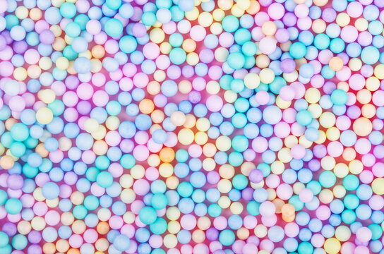 Foam beads of various colors brightly colored abstract background.