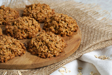 Homemade oatmeal cookies on wooden board on old table background. Healthy Food Snack Concept. Copy space