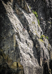 Climber in the rock of the peak in mountains