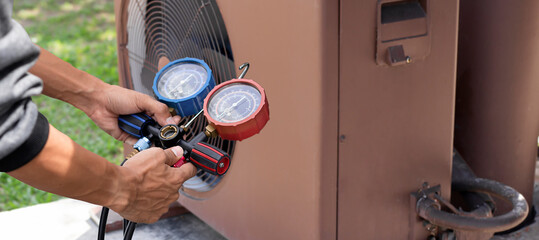 Technician checking the operation of the air conditioner