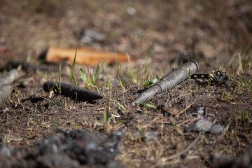 Large-caliber cartridges on burnt earth