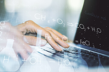 Creative chemistry concept with hands typing on laptop on background. Multiexposure