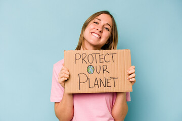 Young caucasian woman holding protect your planet placard isolated on blue background