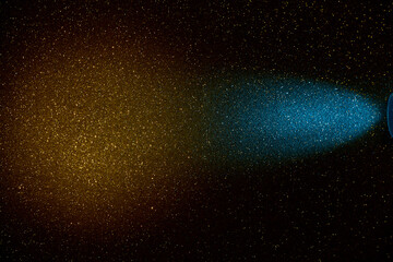 On a dark yellow gradient background in a finely grained light blue beam of light