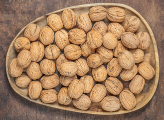  Walnuts on a wooden table.  Walnut fresh nuts Background top view.