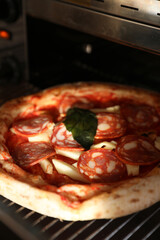 Neapolitan pepperoni pizza in the oven