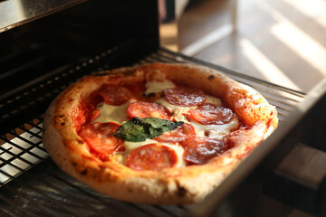 Neapolitan pepperoni pizza in the oven