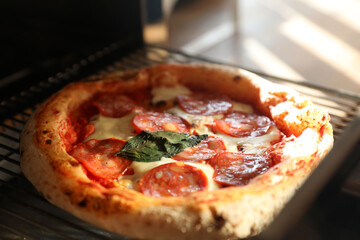 Neapolitan pepperoni pizza in the oven