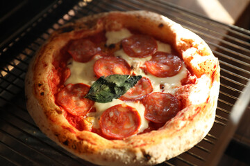 Neapolitan pepperoni pizza in the oven