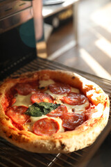 Neapolitan pepperoni pizza in the oven