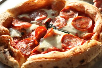 Sliced juicy Neapolitan pepperoni pizza with sausage