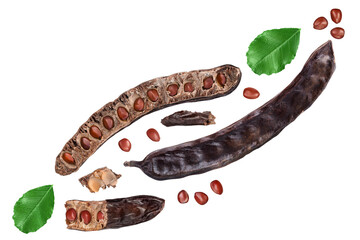 Carob pod and powder isolated on white background with clipping path and full depth of field. Top view. Flat lay