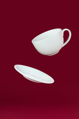 Flying Cup with saucer on red background.