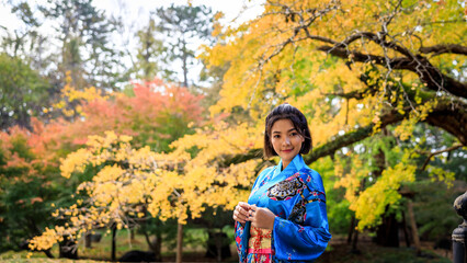 portrait asian woman wearing japanese traditional kimono in autumn park.