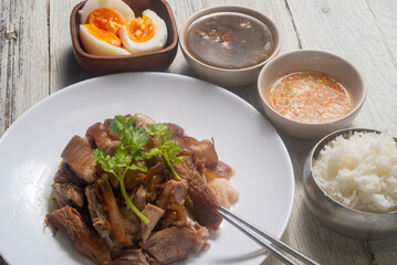 Boiled pork knuckle with chinese herbs. Served with Thai style pickled chili in vinegar, Rice and boiled egg.