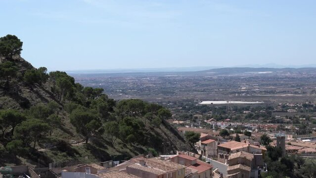 Busot Spain pan view from castle over buildings towards sea, from historic village tourist attraction near El Campello and Alicante
