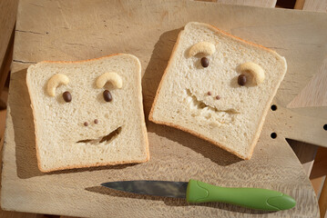 Sandwich bread faces on cutting board