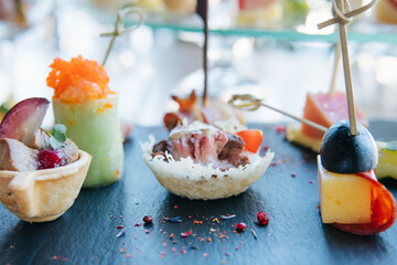 meat tartlets, sushi with salmon and avocado