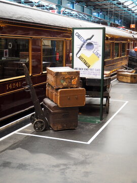 National Railway Museum, York, UK, August 19 2018: Former London Midland and Scottish Railway carriage 3rd class sleeping car from 1928 with antique luggage on station platform
