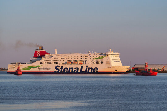 Harwich, Essex, UK, April 12 2021: Stena Line ferry Stena Hollandica steaming past the dockside and red lightships at dusk
