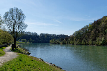 Hiking trail on flood embankment on the river Inn, along the old town of Wasserburg am Inn.