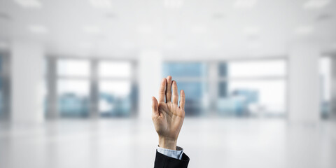 Choosing gesture of businessperson in elegant modern interior in sunshine light