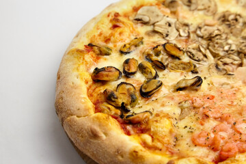 Seafood Pizza mix with mussels and shrimps on wooden cutting board on white