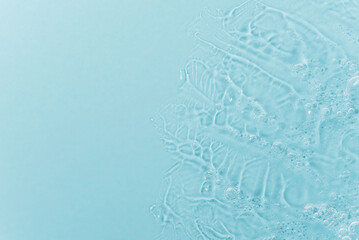 Close up macro Aloe vera gel cosmetic texture blue background with bubbles. Lemongrass gel skincare...