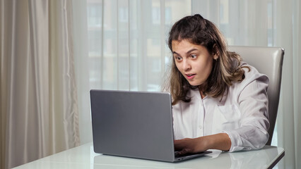 Fototapeta premium Impressed disabled woman freelancer gets paid for successful project working from home on laptop experiencing equality of people with disabilities.